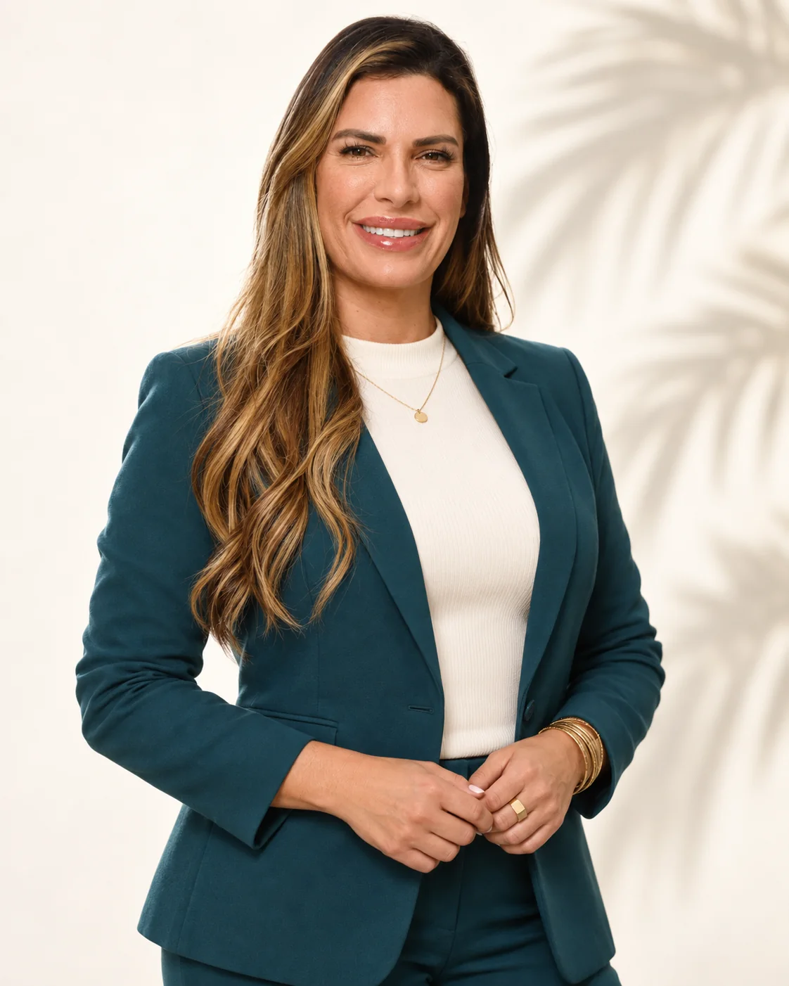 Eileen Rivera Jimenez standing in a teal blazer.